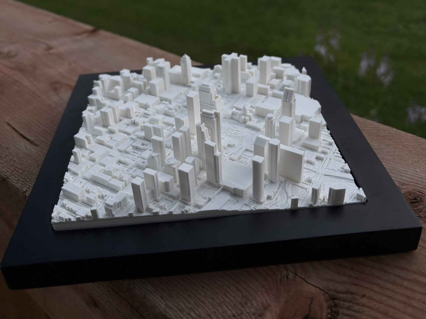 A photograph of a printed Mini City Prints piece on a wooden table