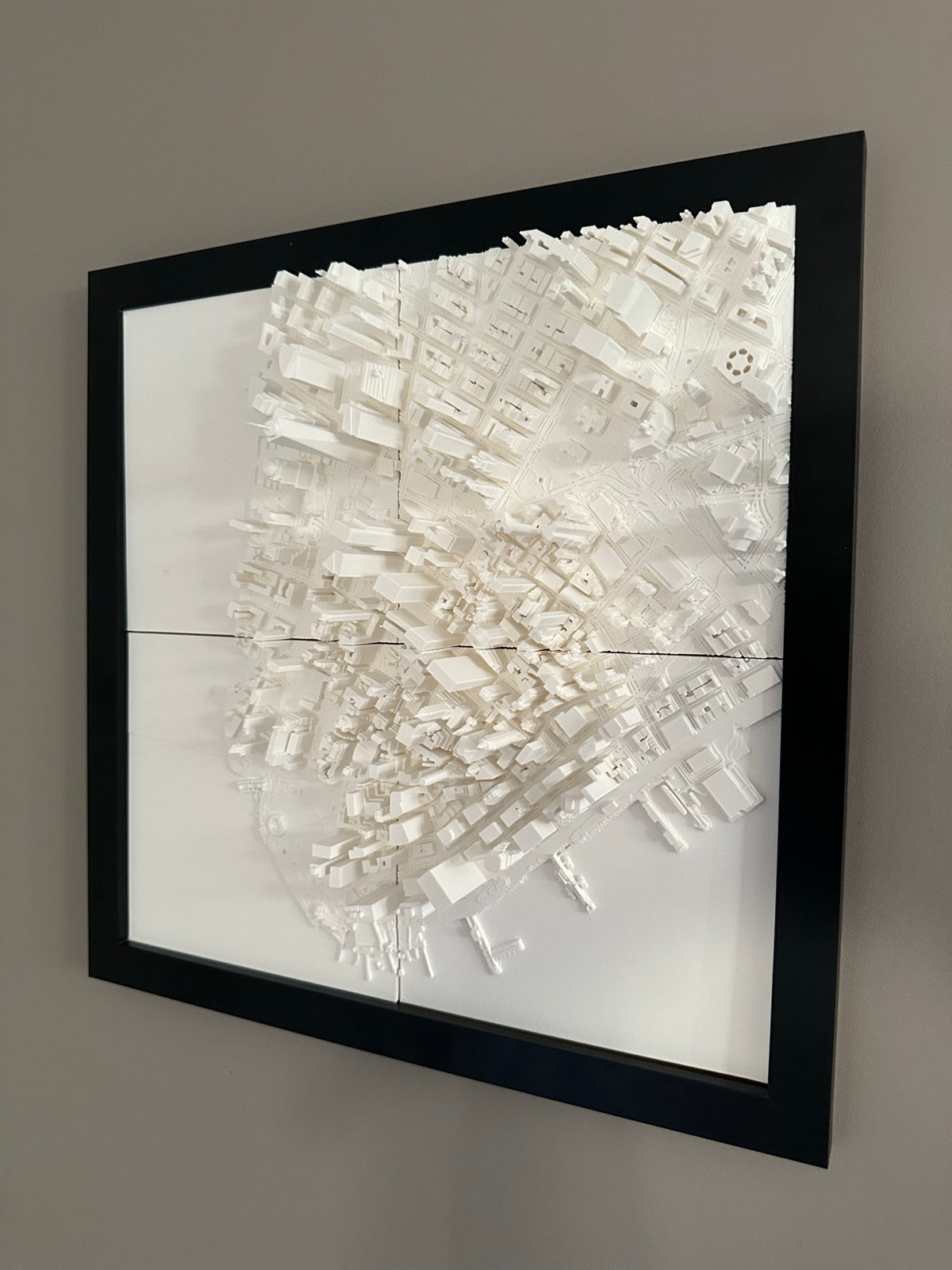 A Mini City Prints framed cityscape on a wall