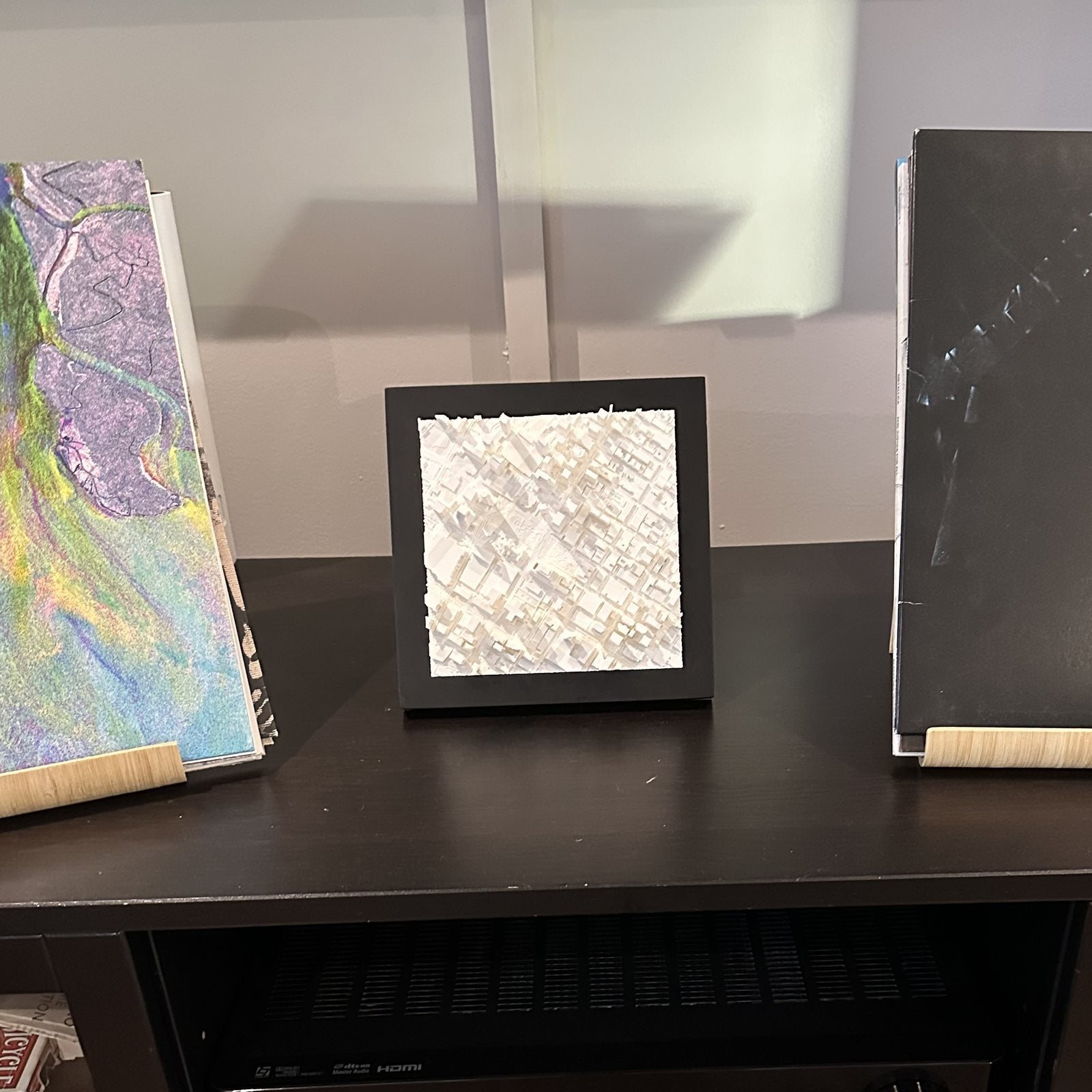 A 6x6 Mini City Prints frame standing on a console beside other art